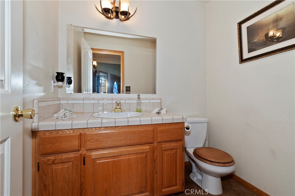 28223 North Bay Road Lake Arrowhead, CA 92352 - Photo 14 of 39 a bathroom with a sink mirror vanity and toilet