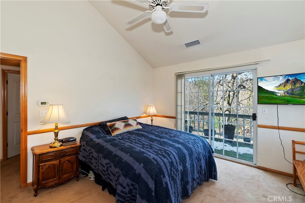 28223 North Bay Road Lake Arrowhead, CA 92352 - Photo 16 of 39 a bedroom with a bed and a large window