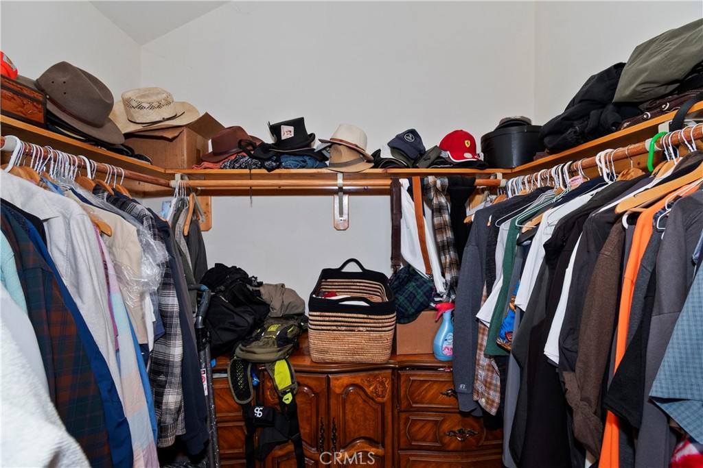 28223 North Bay Road Lake Arrowhead, CA 92352 - Photo 20 of 39 a view of walk in closet with clothes and shoes