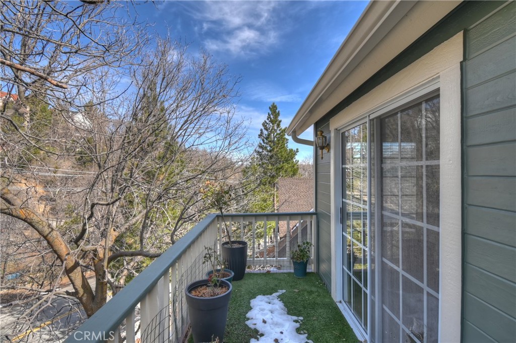 28223 North Bay Road Lake Arrowhead, CA 92352 - Photo 28 of 39 a balcony with wooden fence and trees