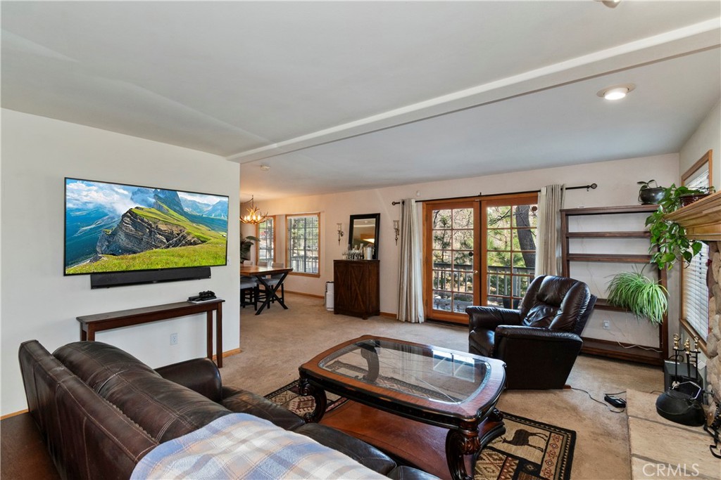 28223 North Bay Road Lake Arrowhead, CA 92352 - Photo 5 of 39 a living room with furniture and a flat screen tv