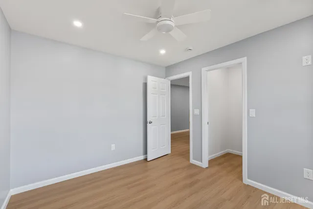 a view of a kitchen with a refrigerator and a car parked in it