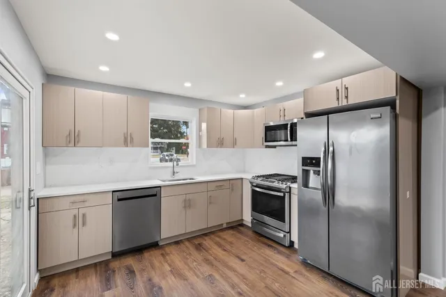 a kitchen with a sink stainless steel appliances and counter space