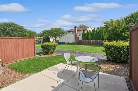 a view of a backyard with furniture and a garden