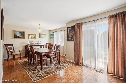 a view of a a dining room with furniture window and wooden floor