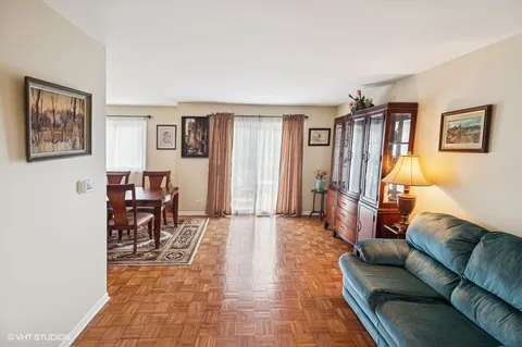 a living room with furniture and a dining table