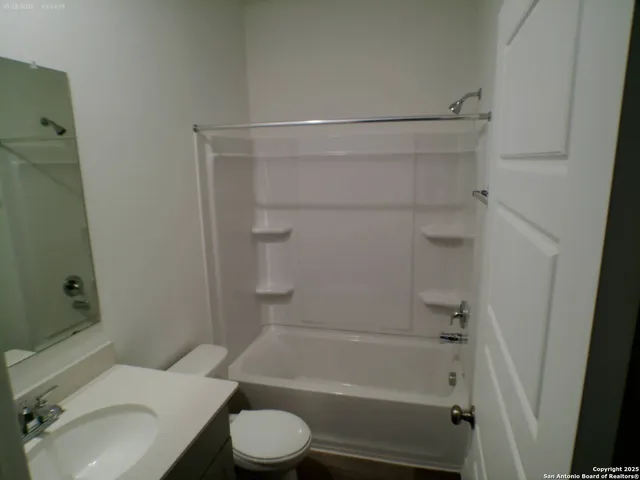 a bathroom with a toilet and shower