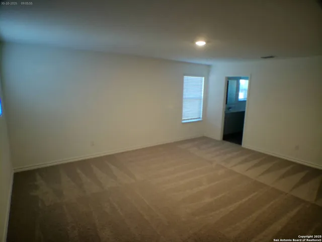 an empty room with a empty space and windows