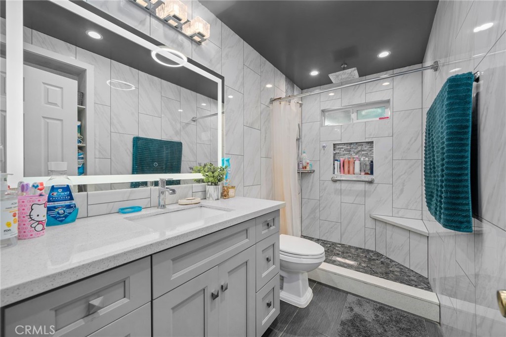 6757 Clifford Street Riverside, CA 92504 - Photo 15 of 25 a bathroom with a double vanity sink toilet and shower