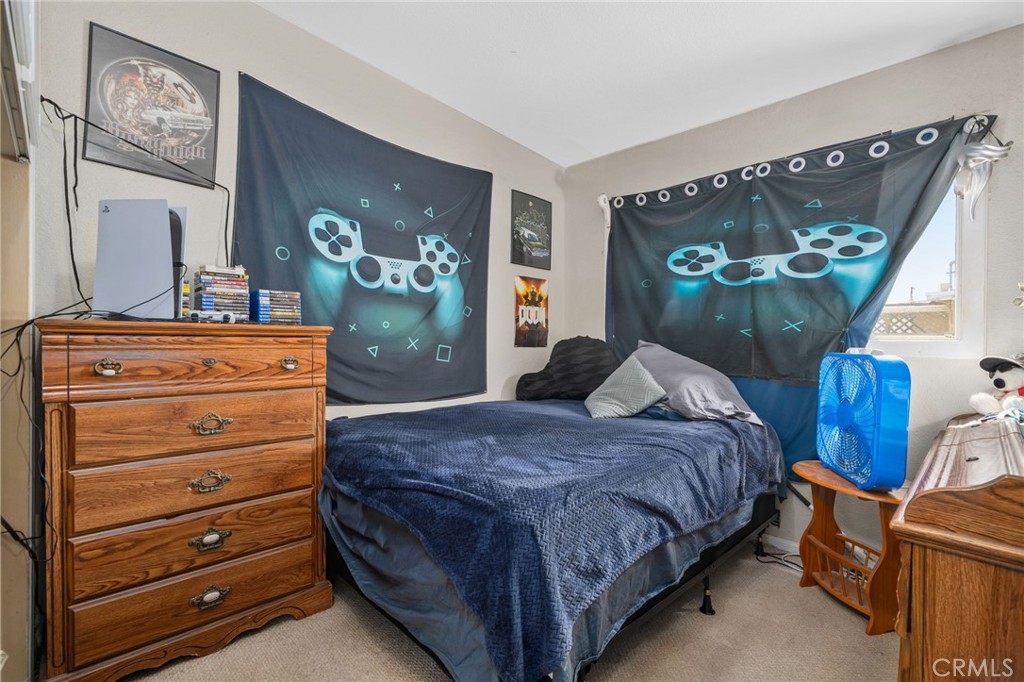 6757 Clifford Street Riverside, CA 92504 - Photo 16 of 25 a bedroom with a bed and a dresser