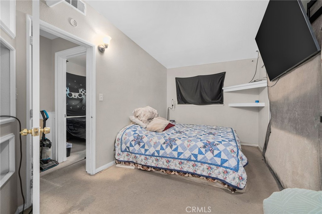 6757 Clifford Street Riverside, CA 92504 - Photo 17 of 25 a bedroom with a bed and walk in closet