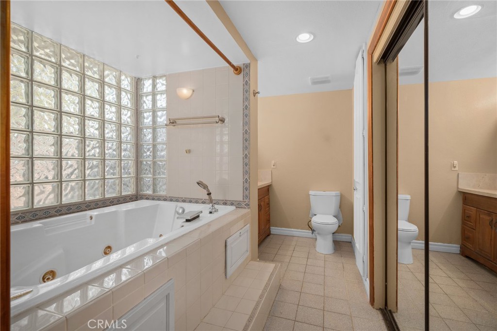 6757 Clifford Street Riverside, CA 92504 - Photo 20 of 25 a bathroom with a bathtub a toilet and a shower