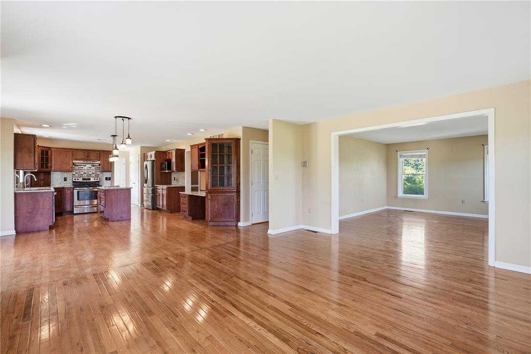 590 Fehr Road Nazareth, PA 18064 - Photo 12 of 79 Polished hardwood flooring flows through this wide-open main level connecting the kitchen and living areas.