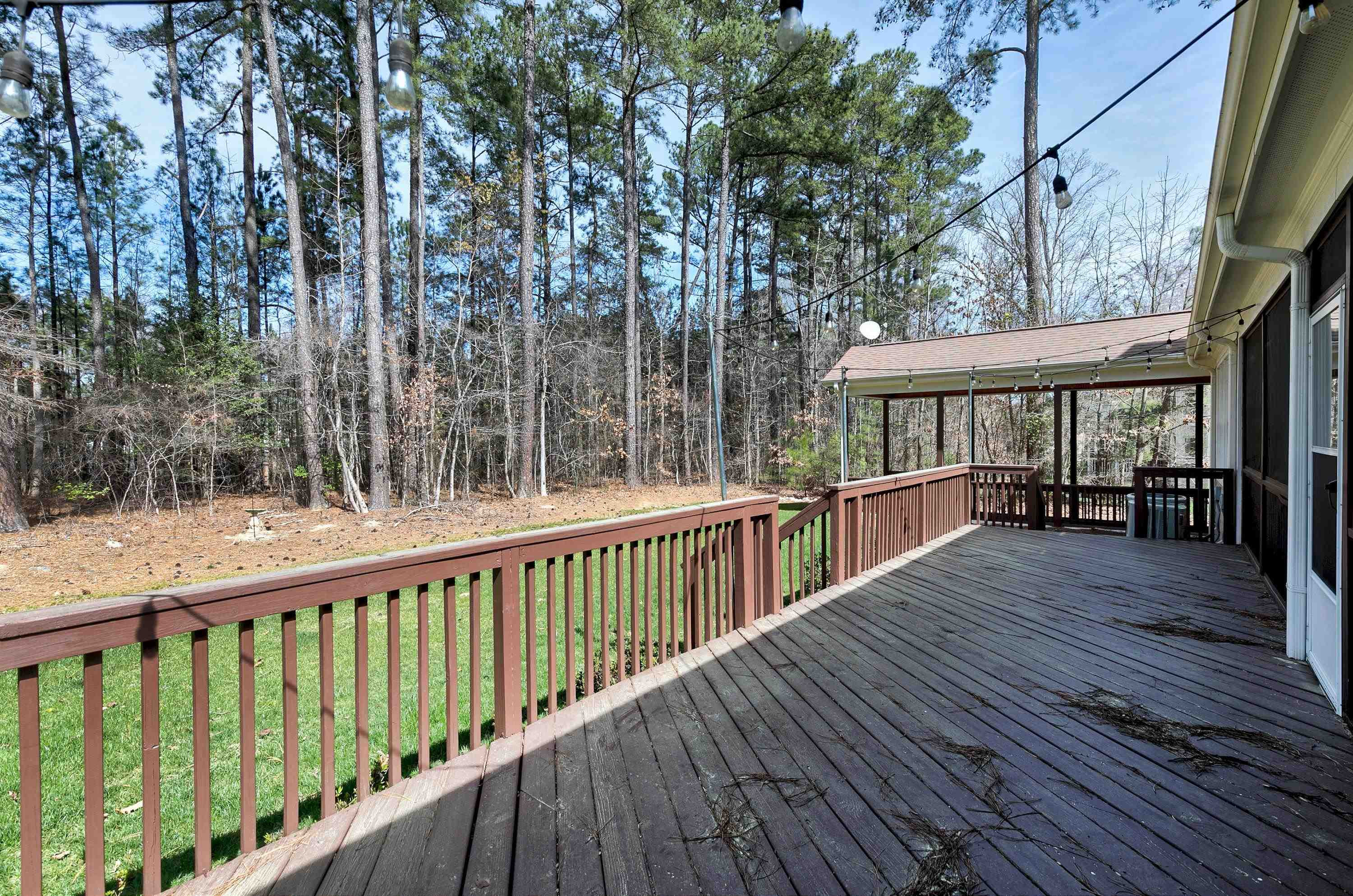 8303 La Matisse Road Raleigh, NC 27615 - Photo 54 of 66 a view of a wooden deck with large trees