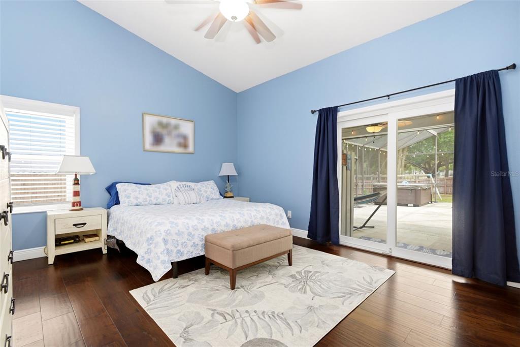 7432 Sparkling Lake Road Orlando, FL 32819 - Photo 23 of 54 a bedroom with a bed and a large window