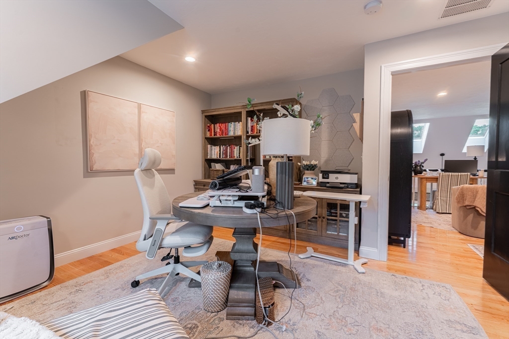38 Cherry Street, Unit B Hudson, MA 01749 - Photo 27 of 33 a view of a workspace with furniture and a kitchen