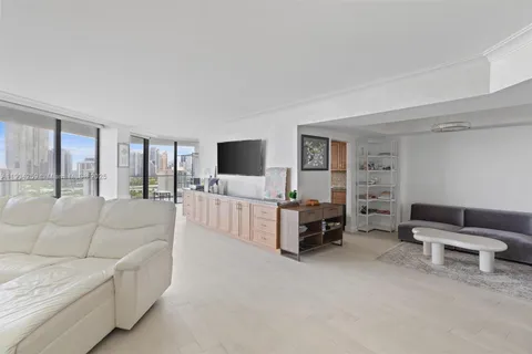 a living room with furniture and a floor to ceiling window