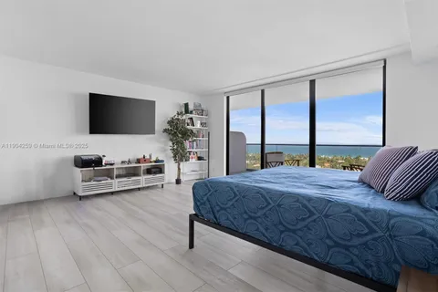 a living room with a couch and next to a window