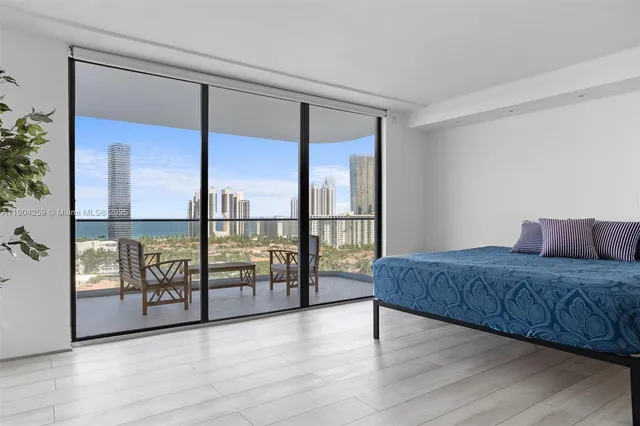 a spacious bedroom with a large bed and a large window