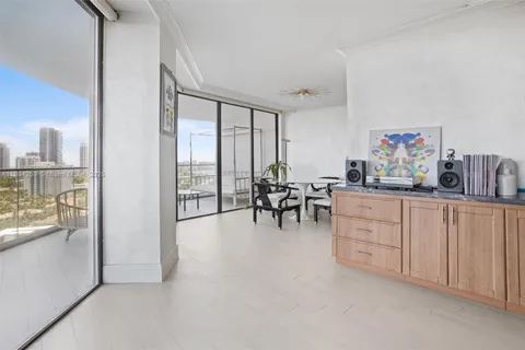 a view of a livingroom with furniture cabinet flat screen tv and next to a window