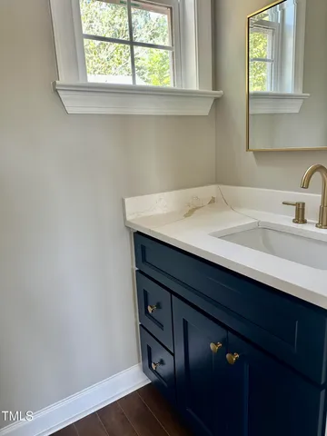 a bathroom with a sink a vanity and a window