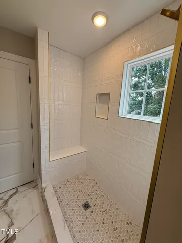 a view of a hallway to a window