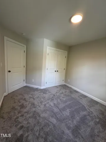 a view of an empty room and a ceiling fan