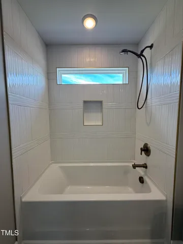 a bathroom with a bathtub and a shower