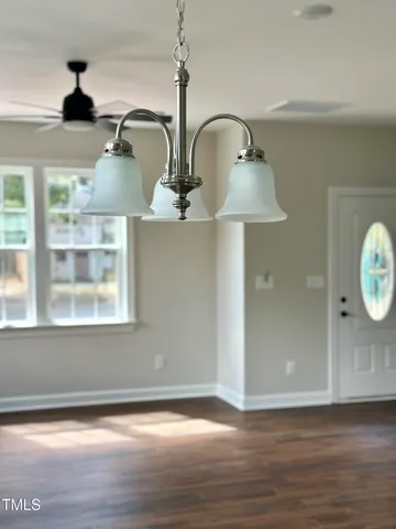 a view of a room with wooden floor and windows