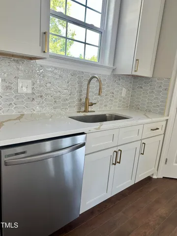a close view of sink and cabinets