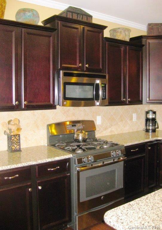 4093 Perth Road, Unit 380 Fort Mill, SC 29707 - Photo 8 of 24 a kitchen with granite countertop a stove and cabinets