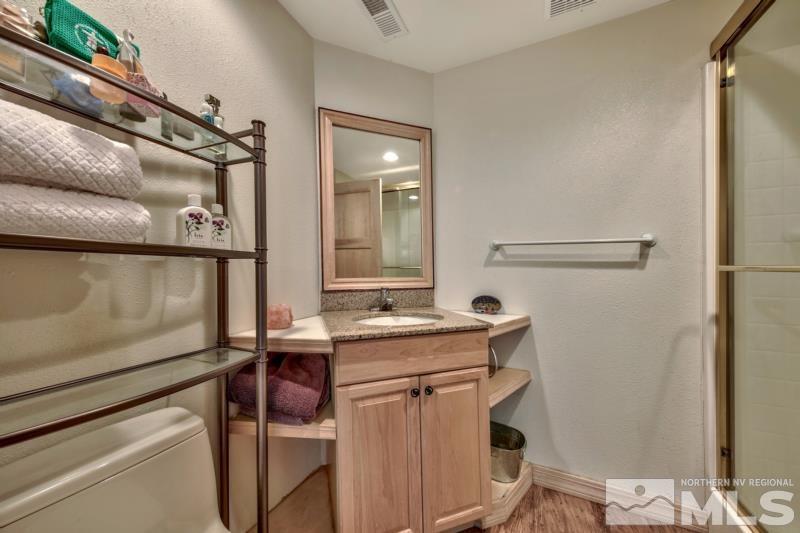 369 Summit Drive Stateline, NV 89449 - Photo 17 of 39 a bathroom with a sink a toilet and mirror