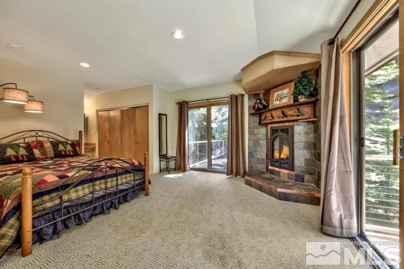 369 Summit Drive Stateline, NV 89449 - Photo 18 of 39 a spacious bedroom with a bed and a large window