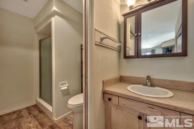 369 Summit Drive Stateline, NV 89449 - Photo 19 of 39 a bathroom with a granite countertop sink toilet and mirror