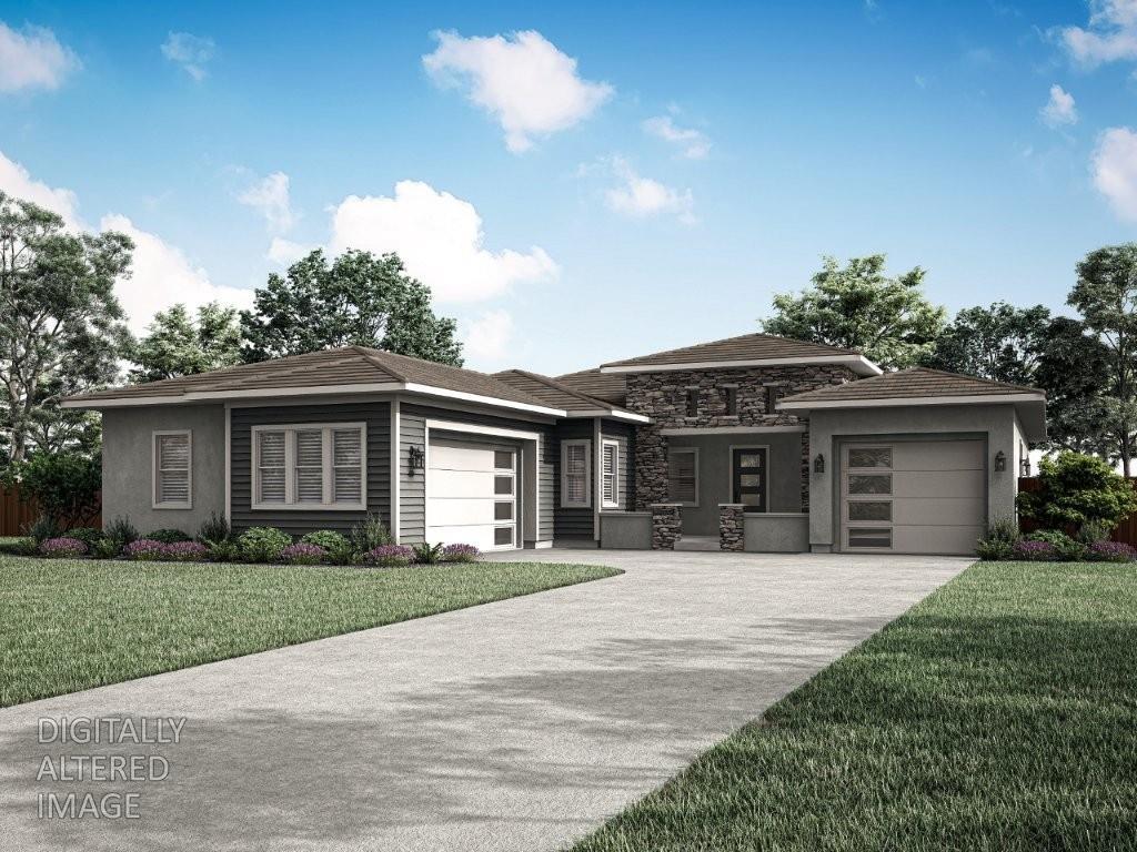 a front view of a house with a yard and potted plants
