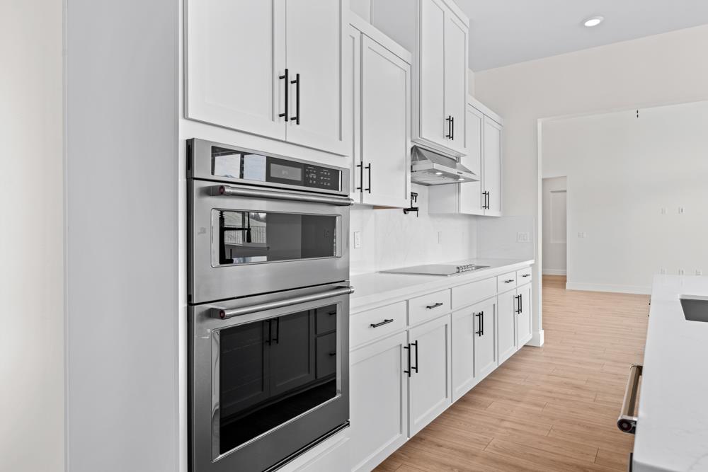 7058 Sheldon Rnch Drive Rancho Murieta, CA 95683 - Photo 11 of 26 a kitchen with granite countertop white cabinets and stainless steel appliances