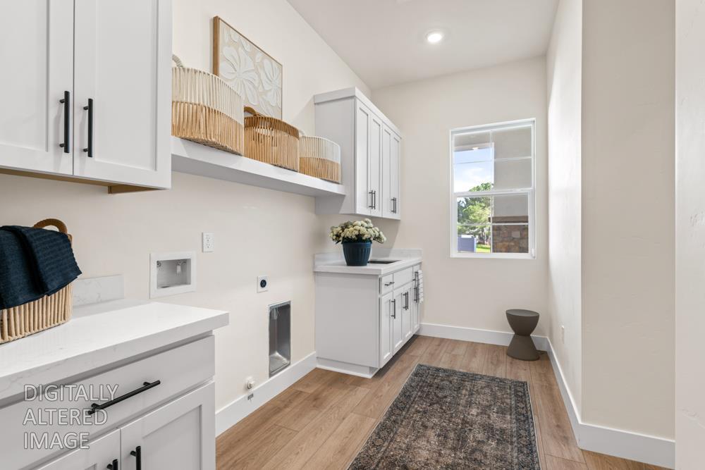 7058 Sheldon Rnch Drive Rancho Murieta, CA 95683 - Photo 16 of 26 a kitchen with stainless steel appliances granite countertop a sink dishwasher stove and white cabinets with wooden floor