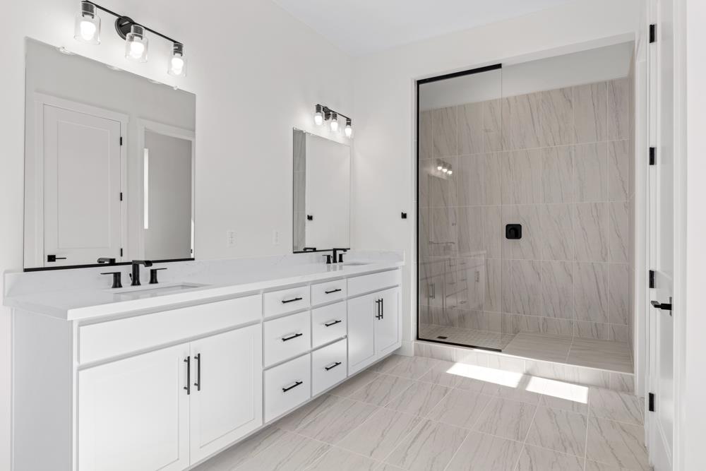 7058 Sheldon Rnch Drive Rancho Murieta, CA 95683 - Photo 24 of 26 a bathroom with a double vanity sink mirror and shower