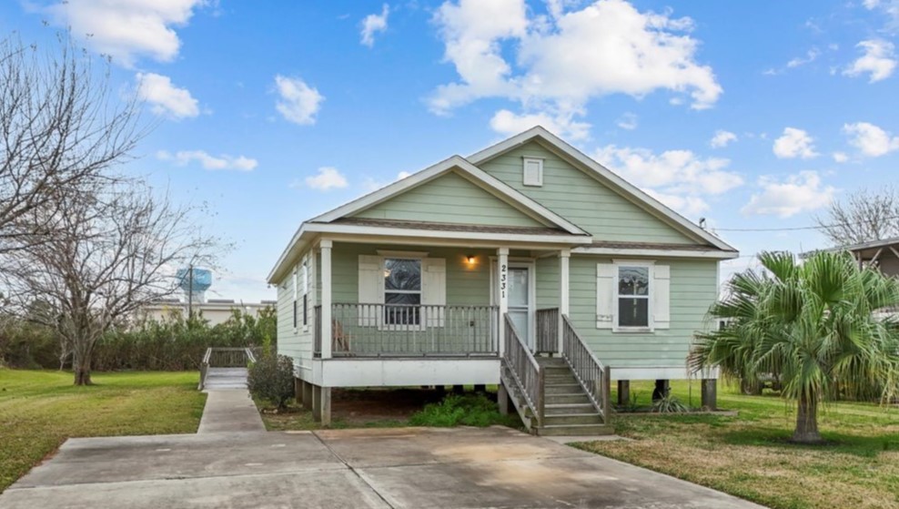 2331 Rue De Lafitte Street Dickinson, TX 77539 - Photo 1 of 32 a front view of a house with a garden