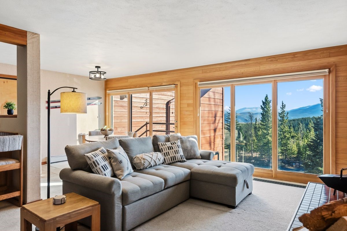 91300 Ryan Gulch Road, Unit 91311 Silverthorne, CO 80498 - Photo 1 of 29 a living room with furniture and a large window