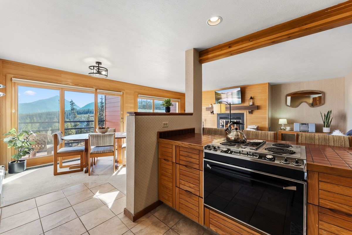 91300 Ryan Gulch Road, Unit 91311 Silverthorne, CO 80498 - Photo 11 of 29 a kitchen with stainless steel appliances granite countertop a stove a sink and a microwave