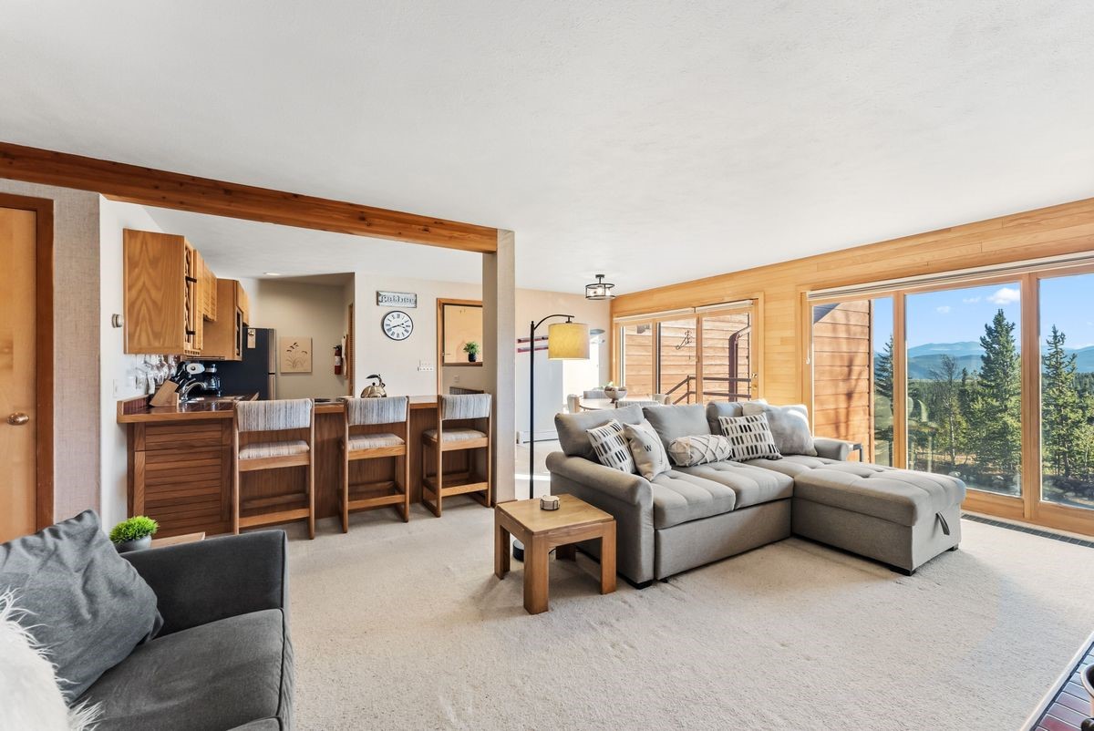 91300 Ryan Gulch Road, Unit 91311 Silverthorne, CO 80498 - Photo 3 of 29 a living room with furniture and large windows