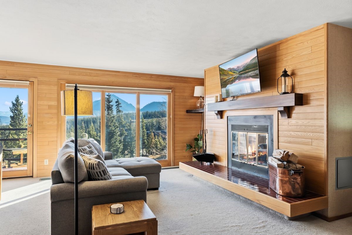 91300 Ryan Gulch Road, Unit 91311 Silverthorne, CO 80498 - Photo 4 of 29 a living room with furniture and a large window