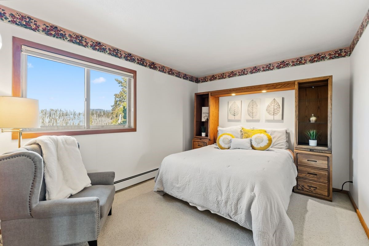 91300 Ryan Gulch Road, Unit 91311 Silverthorne, CO 80498 - Photo 7 of 29 a bedroom with a bed and wooden floor