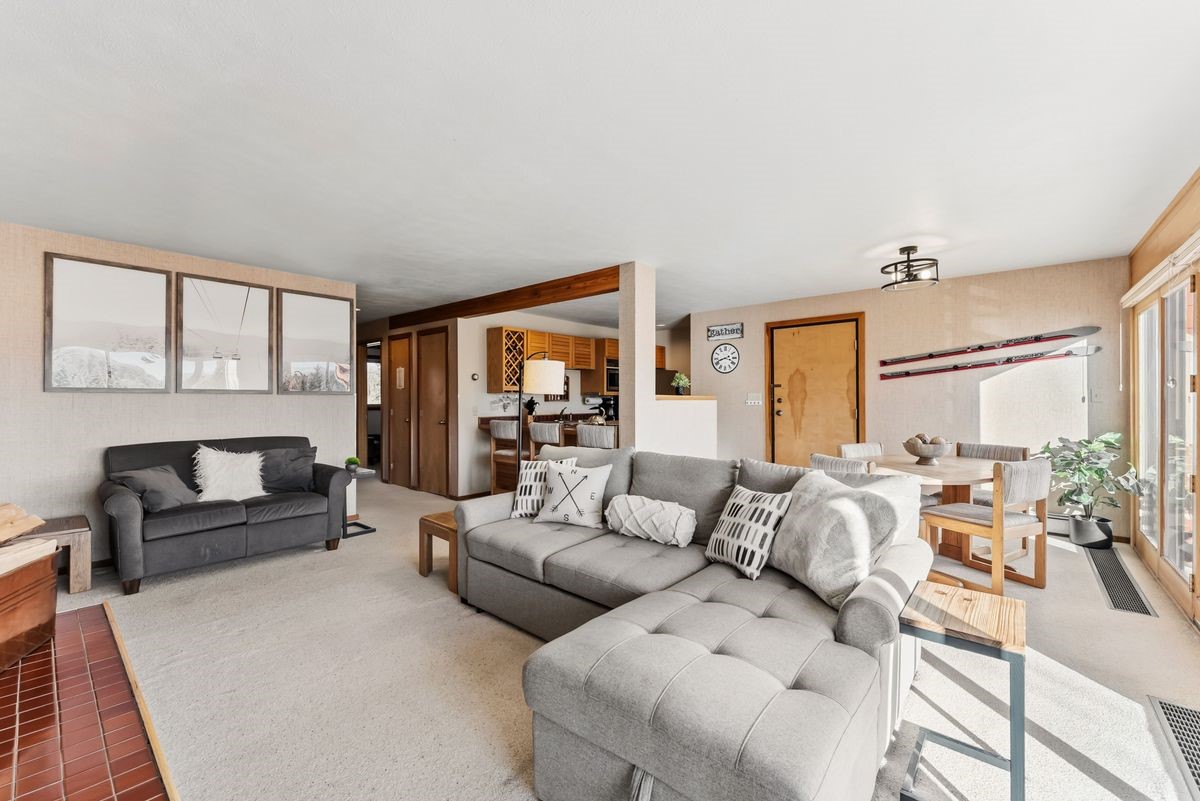 91300 Ryan Gulch Road, Unit 91311 Silverthorne, CO 80498 - Photo 8 of 29 a living room with furniture and a large window