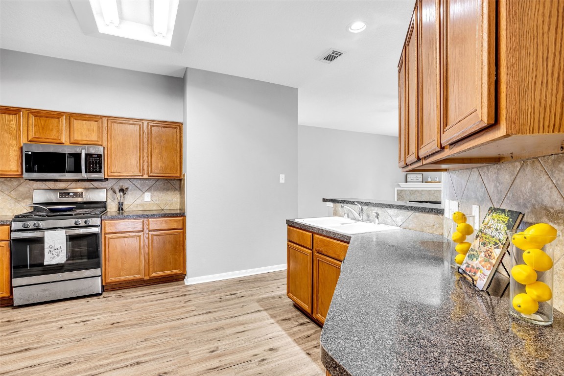5026 Forest Hurst Drive Spring, TX 77373 - Photo 11 of 31 a kitchen with a sink appliances and cabinets