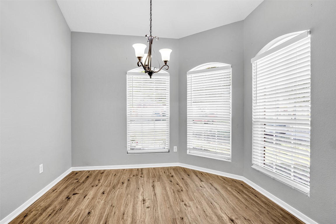 5026 Forest Hurst Drive Spring, TX 77373 - Photo 14 of 31 a view of an empty room with wooden floor and a window