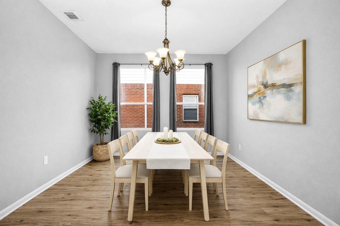 5026 Forest Hurst Drive Spring, TX 77373 - Photo 16 of 31 a dining room with furniture a chandelier and wooden floor
