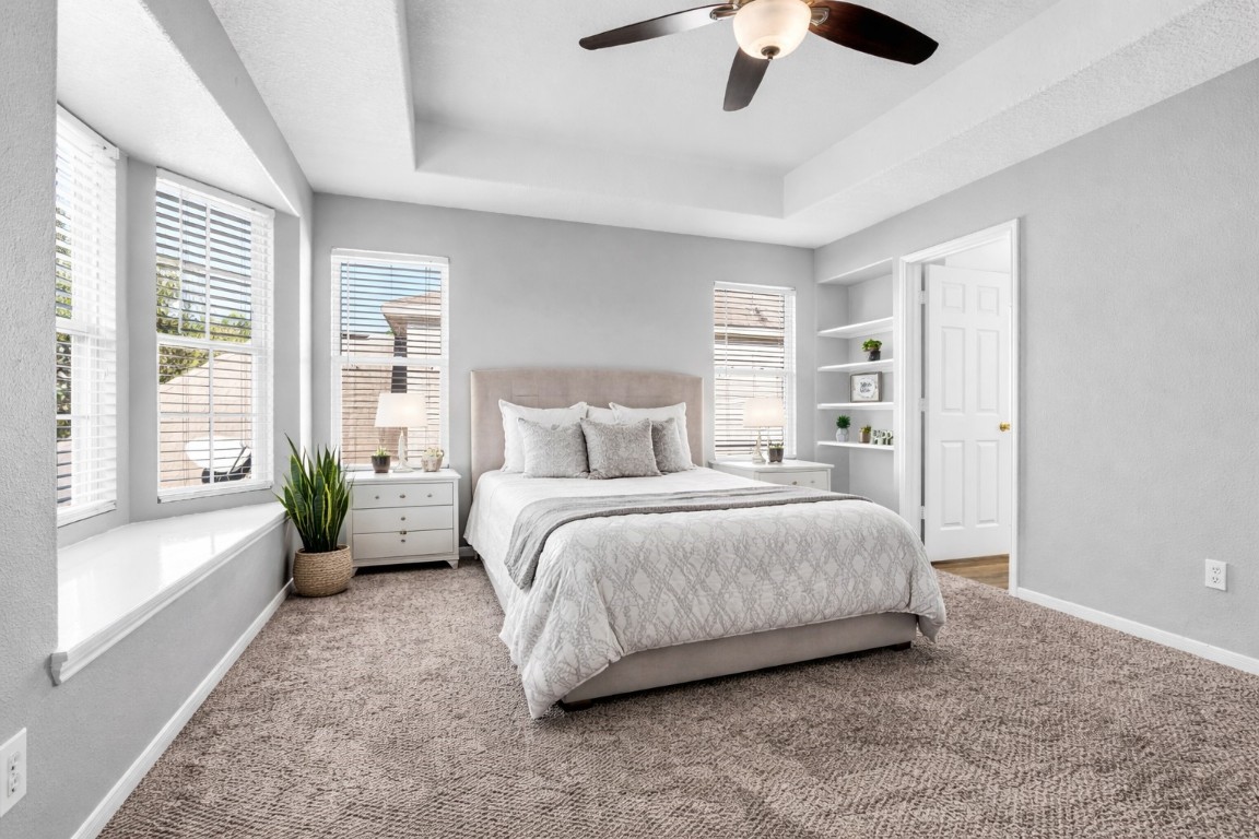 5026 Forest Hurst Drive Spring, TX 77373 - Photo 22 of 31 a bedroom with a large bed and a chandelier fan