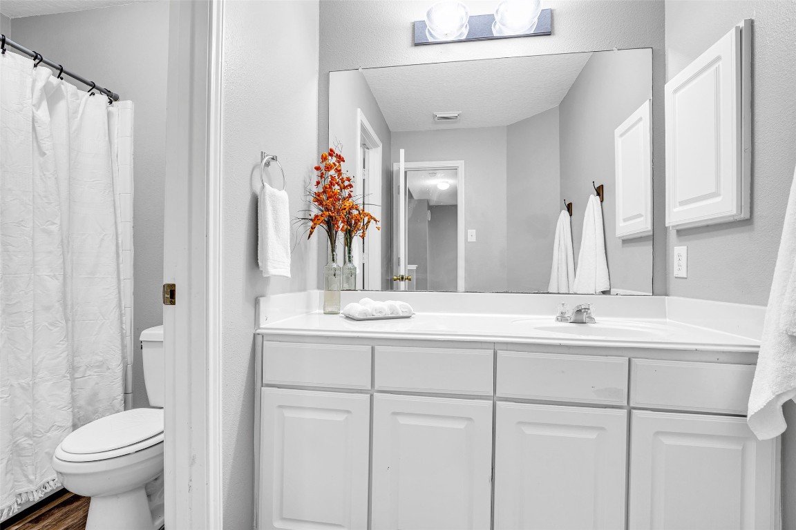 5026 Forest Hurst Drive Spring, TX 77373 - Photo 26 of 31 a bathroom with a double vanity sink toilet and a mirror